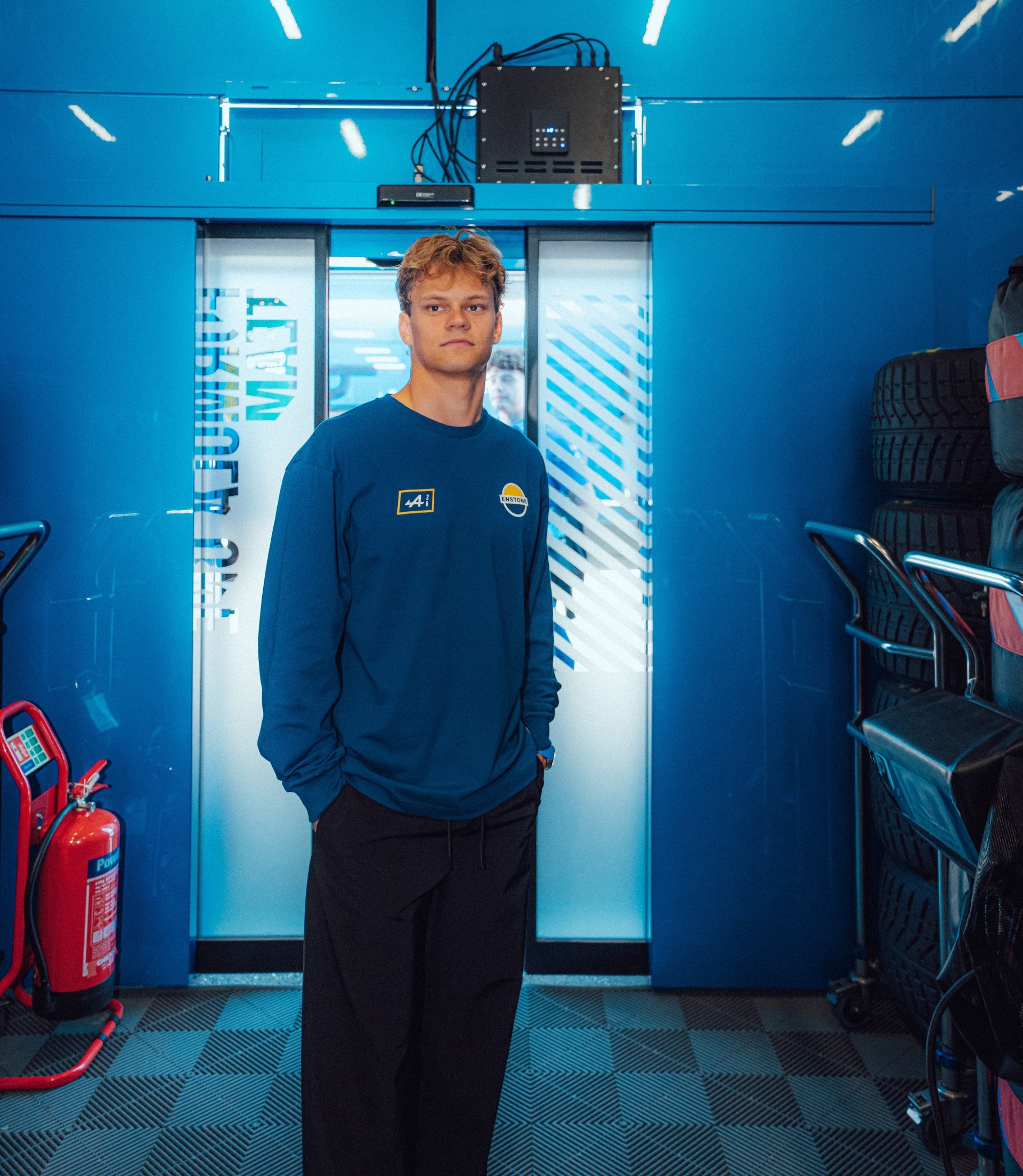 Person wearing blue Alpine Classic F1 Long Sleeve T Shirt with sponsor logos