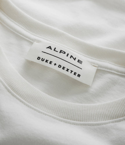 Close up of white fabric with a Duke & Dexter label on the Unisex BWT Alpine vintage T shirt