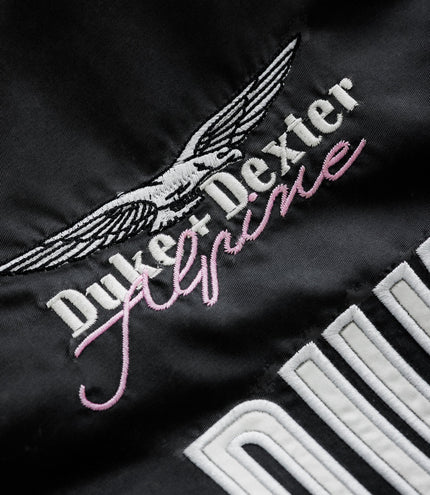 Wing emblem and Alpine branding in white on black fabric of the jacket