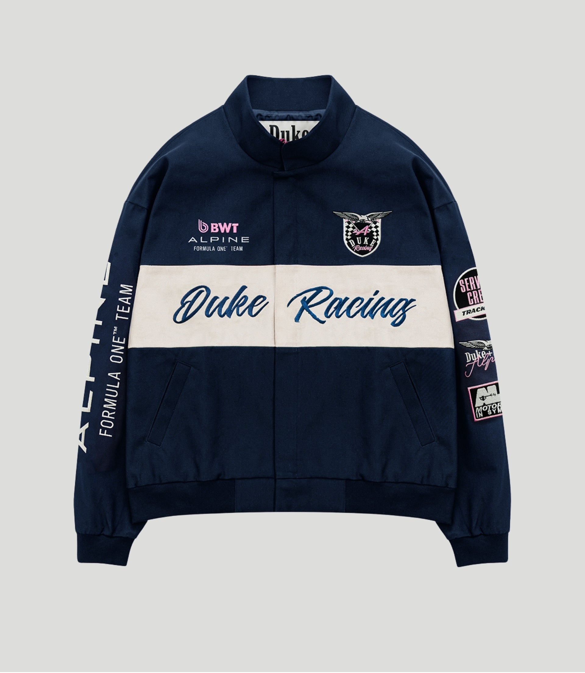Navy BWT Alpine racing jacket with a white centered panel, Duke Racing script and crest patch on the chest