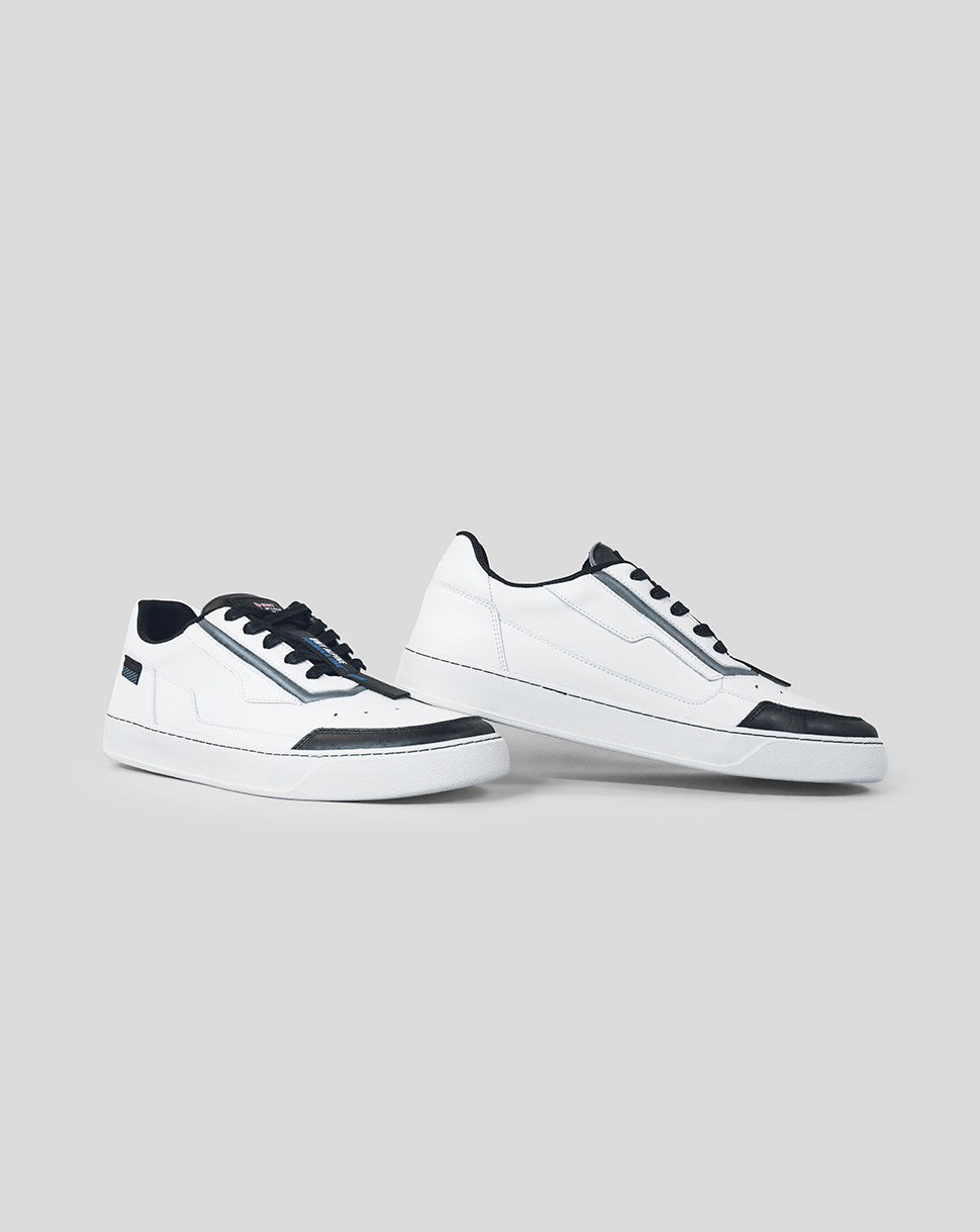 Two white BWT Alpine Endstate sneakers with black laces arranged side by side on a gray background