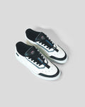 White Endstate sneaker with black detailing and laces shown from an overhead angle