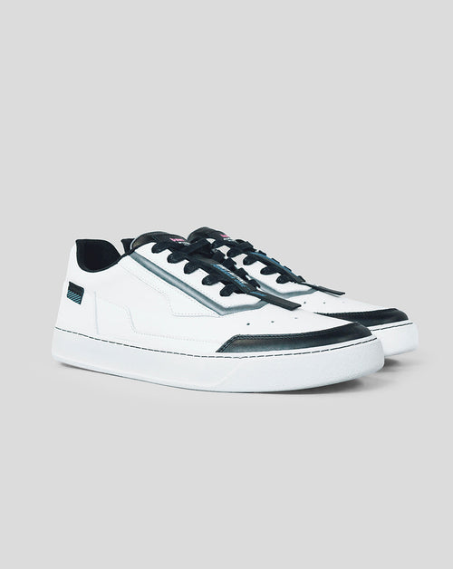 Pair of white BWT Alpine Endstate sneakers with black toe caps and metallic side stripe viewed from a three-quarter angle