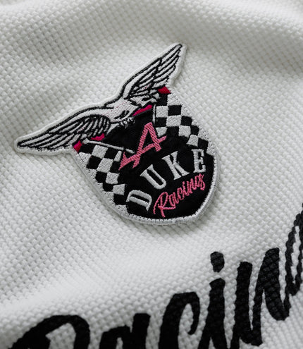 Close up of embroidered wing badge on white waffle fabric
