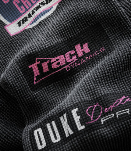 Pink Duke & Dexter branding printed on black waffle fabric.